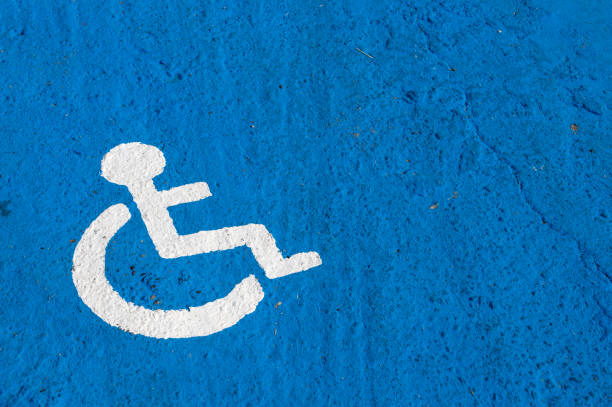 istock White disabled parking sign painted on blue background 824882430