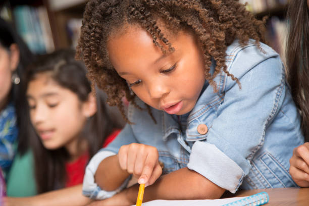 istock Elementary-age school girls collaborate on homework. 824883034