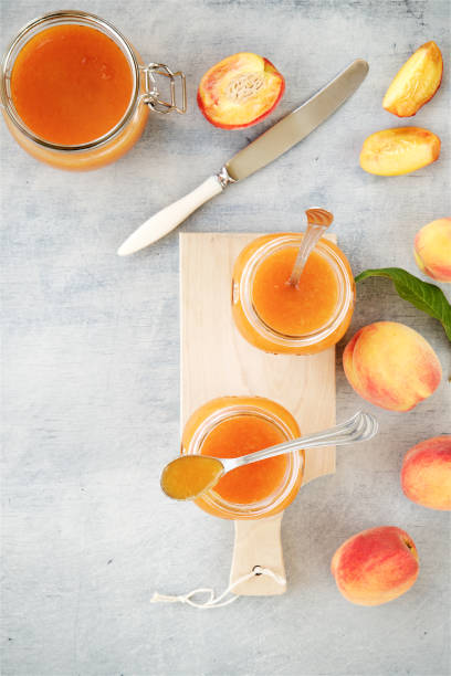istock Apricot or peach jam in glass jars 824886372
