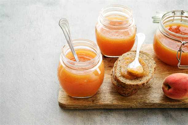 istock Apricot or peach jam in glass jars 824886476