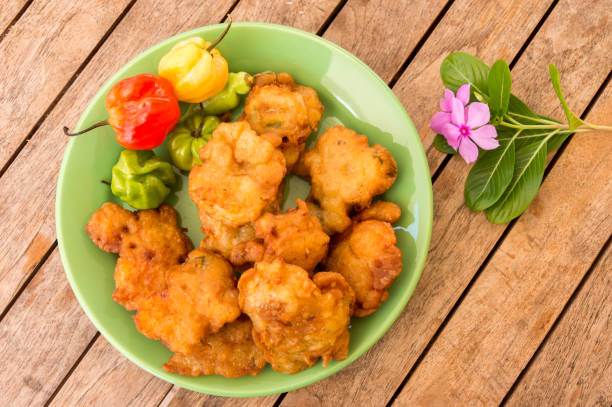Salt cod fritters (accras de morue) on a plate with habanero peppers in Martinique stock photo