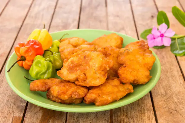 Photo of Salt cod fritters (accras de morue) on a plate with habanero peppers in Martinique