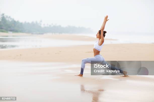 Caucasian Woman Practicing Yoga At Seashore Of Tropic Ocean Stock Photo - Download Image Now