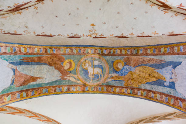Lamb with a cross and flag, lamb of God  and two angels, a romanesque painting Lamb with a cross and flag, lamb of God  and two angels, a romanesque painting i Jorlunde church, Denmark, July 24, 2017 agnus dei stock pictures, royalty-free photos & images