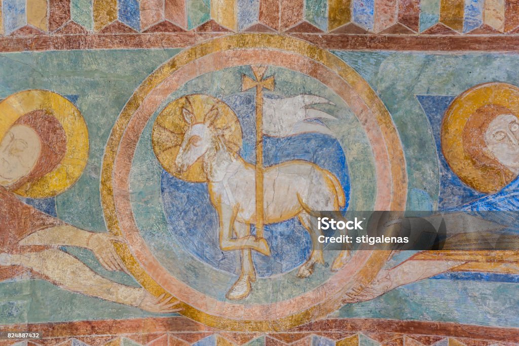 Lamb of God, a medieval fresco painting Lamb of God, a medieval fresco painting in blue, Jorlunde church, Denmark, July 24, 2017 Lamb - Animal Stock Photo