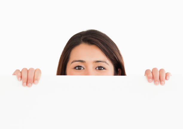 istock Lovely woman hidding behind a board 824887720