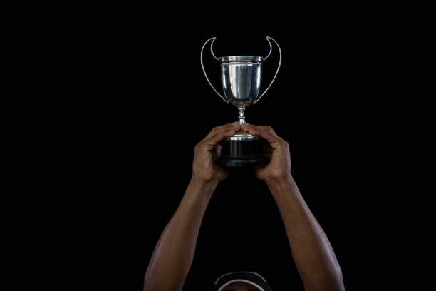 istock Cropped hand on sportsperson holding trophy 824893366