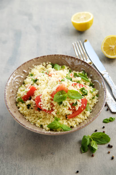 istock Couscous with parsley, tomato, lemon and olive oi 824893458