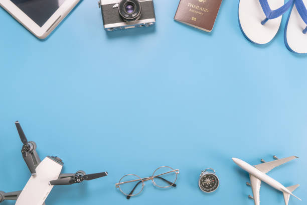 istock Summer travel Objects and Gadgets on blue with middle copy space 824900696
