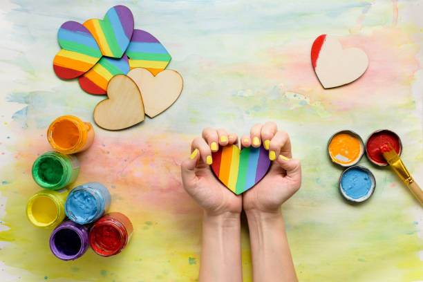 istock Hands holding handmade lgbt hearts 824903134