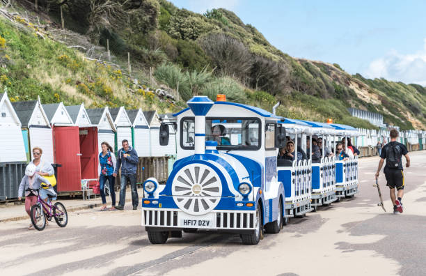 Land train with tourists on Bournemouth Beach Land train with tourists on Bournemouth Beach. Other people walk along the promenade. boscombe photos stock pictures, royalty-free photos & images