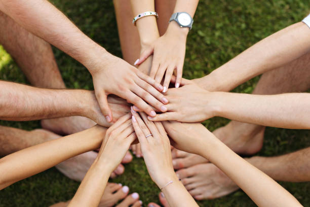 istock Group of friends bonding hands together 824907108