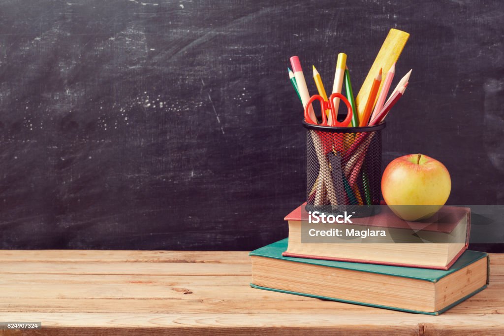 Back to school background with books, pencils and apple over chalkboard Apple - Fruit Stock Photo