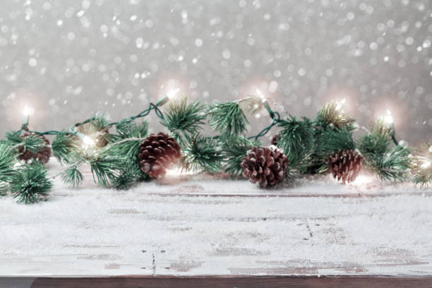 istock Christmas holiday background with empty wooden white table and christmas lights 824907580