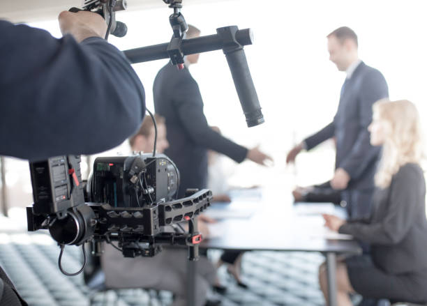 istock Videographer making video of business people 824910178