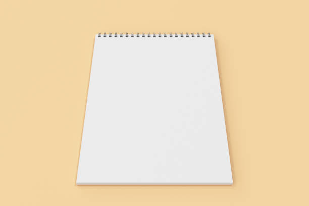 istock Blank white notebook with metal spiral bound on orange background 824914296