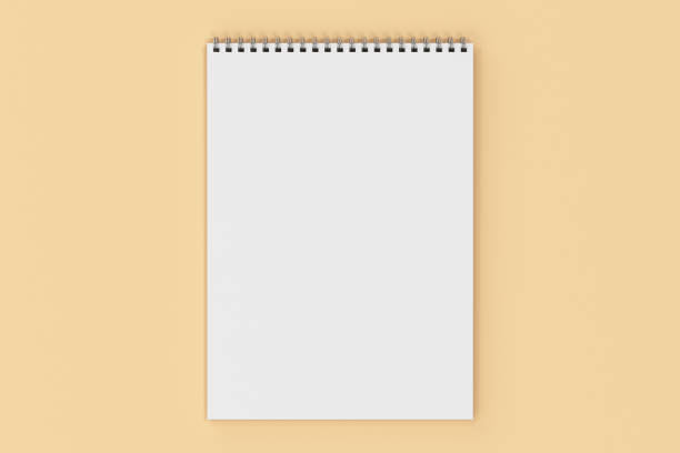 istock Blank white notebook with metal spiral bound on orange background 824914512