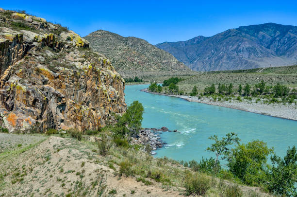 istock Summer mountain landscape with turquoise river and colorful rocks 824914520