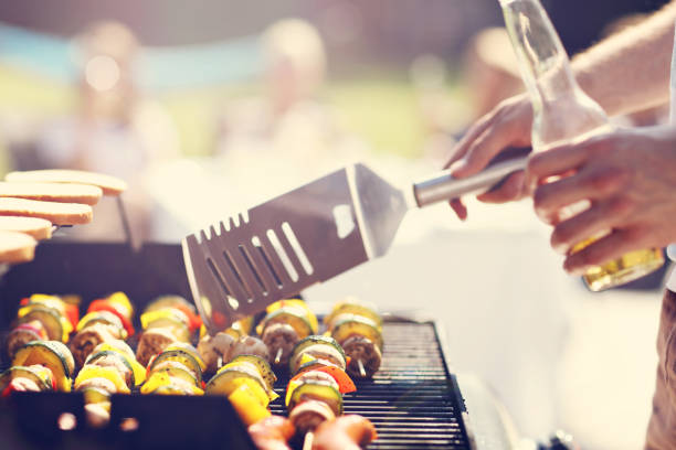 istock Friends having barbecue party in backyard 824917396