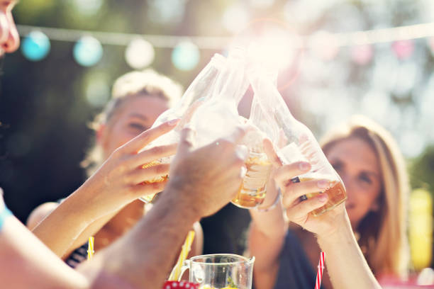 istock Friends having barbecue party in backyard 824917636