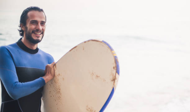 istock Smiling surfer in the sea 824917638