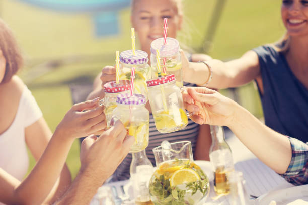 istock Friends having barbecue party in backyard 824917660