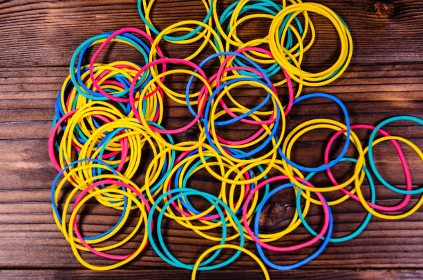 istock Multicolored rubber bands on wooden table. Top view 824920552