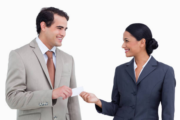 istock Smiling sales partner exchanging business cards 824924374