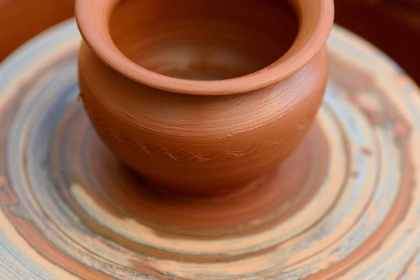 istock Potter making ceramic pot on the pottery wheel 824924922