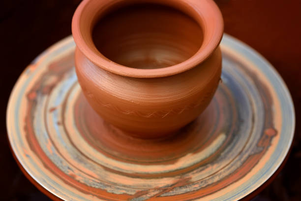 istock Potter making ceramic pot on the pottery wheel 824924988