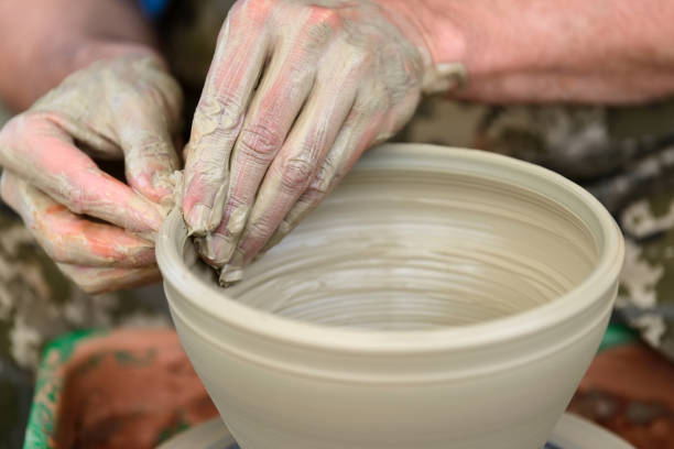 istock Potter making ceramic pot on the pottery wheel 824925008