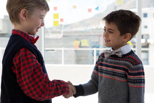 istock Kids as business executives shaking hands 824931896