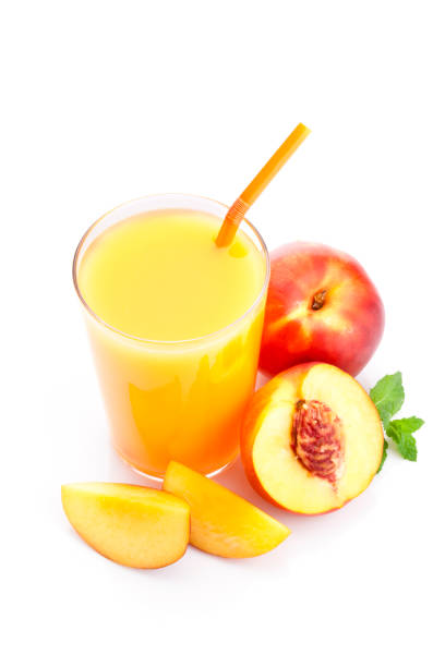 istock Peach juice glass isolated on white background 824932344