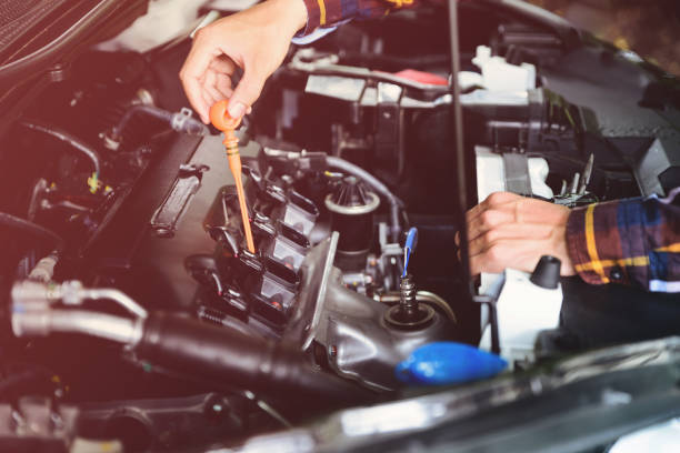 istock Close up hands checking lube oil level of car engine from deep-stick for service and maintenance concept vintage tone. 824934586