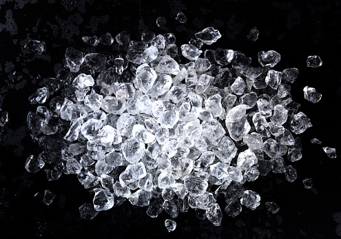 Crushed ice on black background. Top view