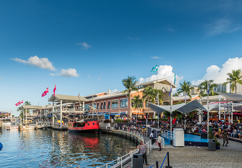 Miami, Florida, USA - July 29, 2017: Sunny day at crowded Miami Bayside Marketplace with a lot of shopping and dining options for families including boat renting. It is located between the Bayfront Park to the South end, and the American Airlines Arena to the North.