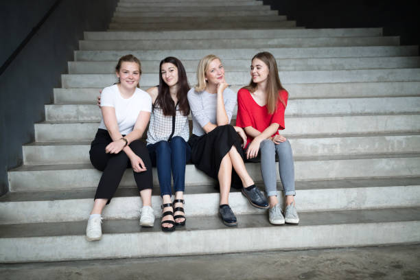 istock Young female students sitting on stairs 824959442
