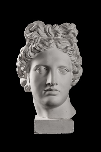 Gypsum statue of Apollo's head on a black background