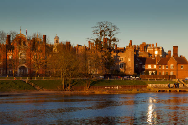 Hampton Court Palace facade Medium shot of the facade of the Hampton Court Palace with the Union Jack in London, England, UK hampton court palace stock pictures, royalty-free photos & images