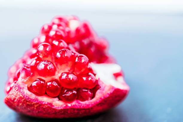 pomegranate fruit segment on dark vintage background  with copy space - usa restaurant flower bed beauty in nature imagens e fotografias de stock