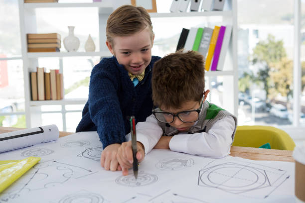 istock Kids as business executives drawing graphs 824966314