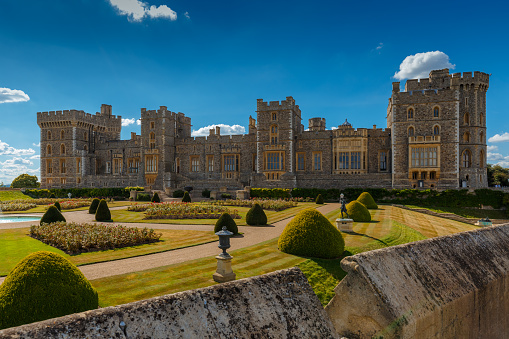 A wide view of the medieval Windsor Castle and gardens bathed in glorious sunny weather