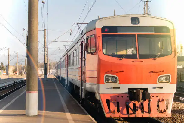 Old passenger train, red. Stands on the platform