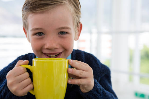 istock Boy as business executive holding coffee mug 824966758