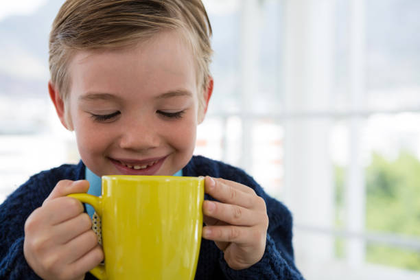 istock Boy as business executive holding coffee mug 824966766