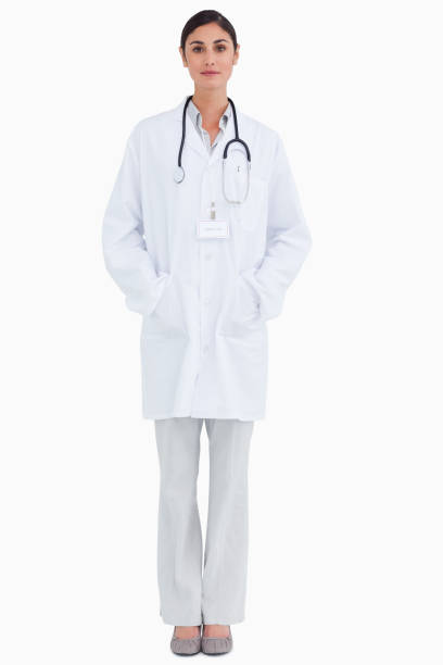 istock Serious looking female doctor with hands in her pockets 824970578