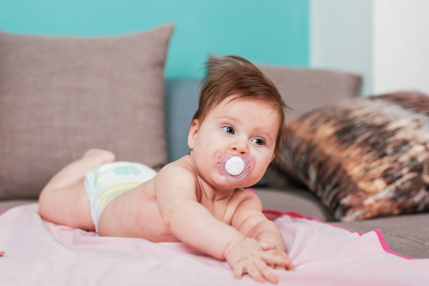 istock Cute baby girl with pacifier 824981730