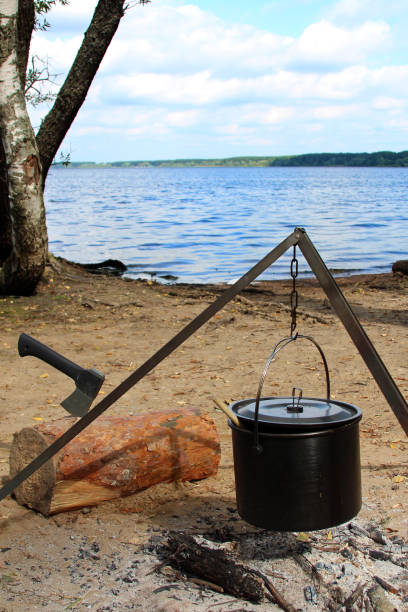 istock the pot over the fire and axe in log 824987894