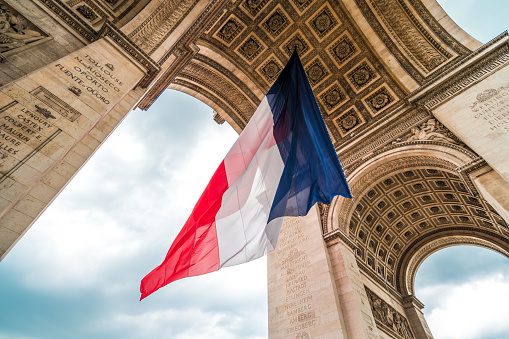 The flag of france at the  Arc de Triomphe monument during bastille day