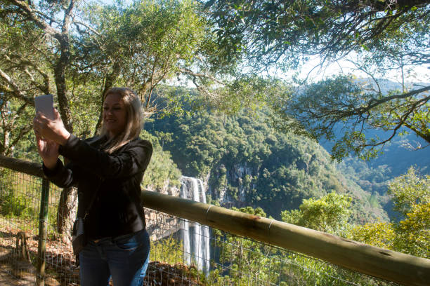 istock Woman taking a selfie in the Caracol Waterfall 824991064